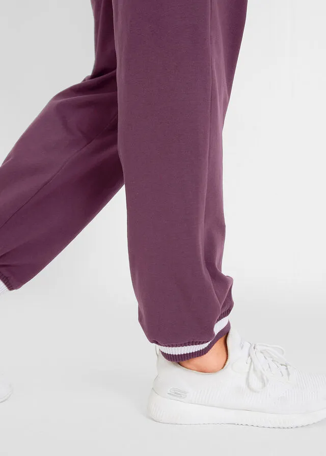 Pantalón deportivo con bolsillos con cierre morado intenso